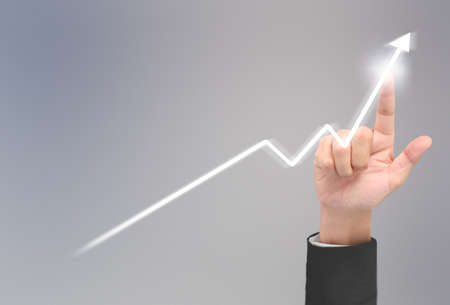 Businessman plan graph growth and increase of chart positive indicators in his businessの写真素材
