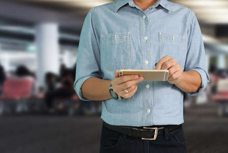 man hand holding smartphone device and touching screenの写真素材