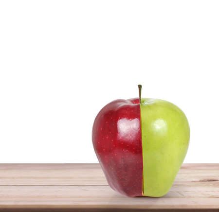 apple and orange on white a wooden tableの写真素材