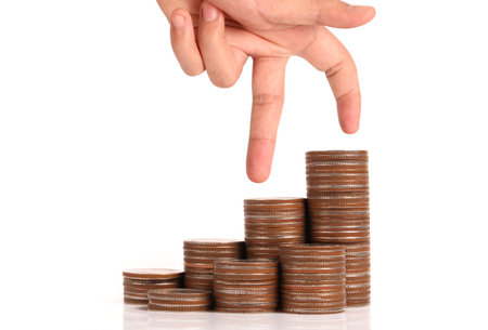 Money coin stack growing business in hand,Saving money concept
