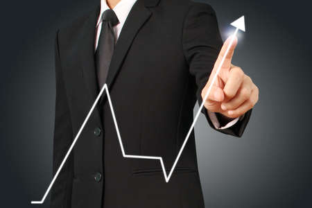 businessman with financial symbols coming from hand ,touch chart stockの写真素材