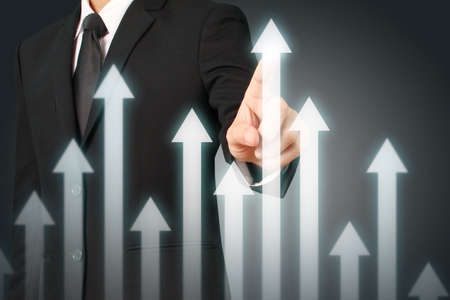 businessman with financial symbols coming from hand ,touch chart stockの写真素材