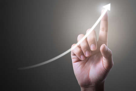 Businessman plan graph growth and increase of chart positive indicators in his businessの写真素材