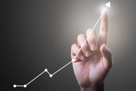 Businessman plan graph growth and increase of chart positive indicators in his businessの写真素材