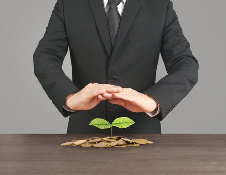 Human hand putting coin to money, business ideas