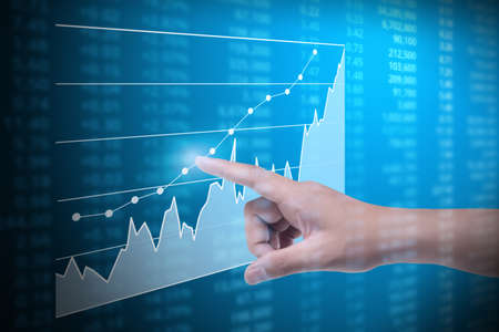 Investment concept,hand with financial chart symbols coming from handの写真素材
