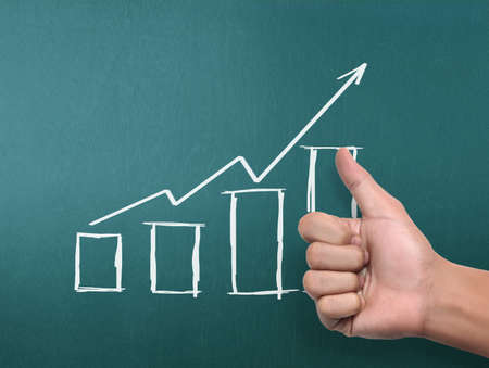 drawing results graph with white chalk on blackboardの写真素材