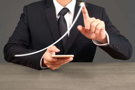 Investment concept,hand with stock financial chart symbols coming from handの写真素材