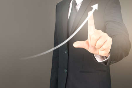 Businessman plan graph growth and increase of chart positive indicators in his businessの写真素材