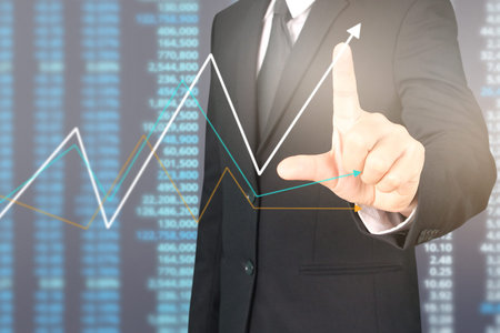 Businessman plan graph growth and increase of chart positive indicators in his business