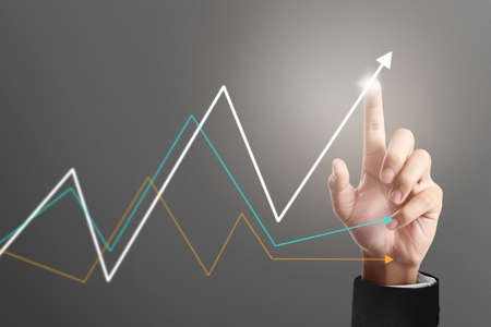 Businessman plan graph growth and increase of chart positive indicators in his businessの写真素材
