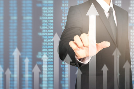 Businessman plan graph growth and increase of chart positive indicators in his businessの写真素材