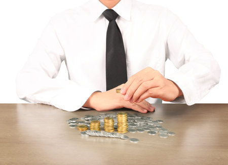 human hand putting coin to money, business ideasの写真素材