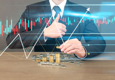 human hand putting coin to money, business ideasの写真素材