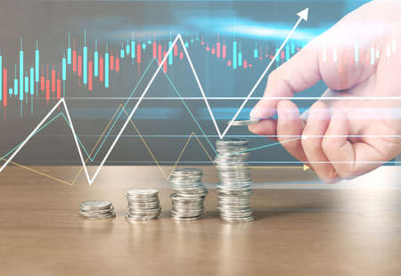 human hand putting coin to money, business ideasの写真素材