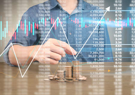 human hand putting coin to money, business ideasの写真素材