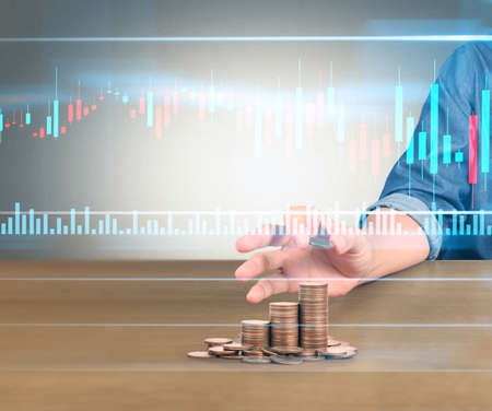 human hand putting coin to money, business ideasの写真素材