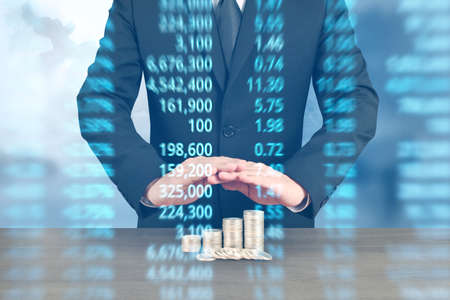 human hand putting coin to money, business ideasの写真素材