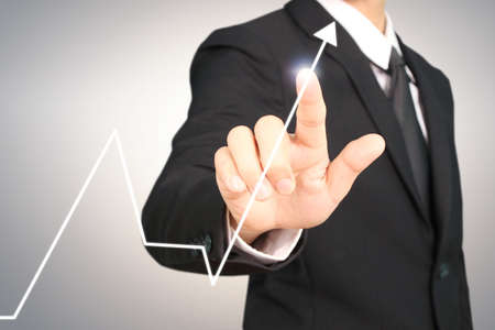 businessman with financial symbols coming from hand ,touch chart stockの写真素材