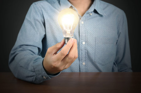 holding lightbulb in a hand