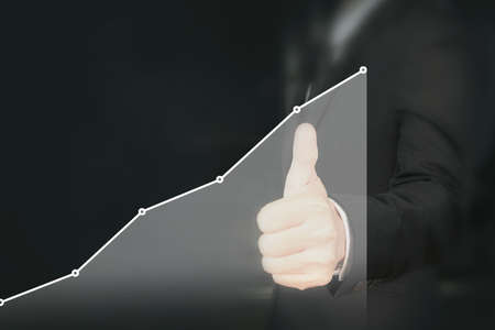 Businessman plan graph growth and increase of chart positive indicators in his businessの写真素材
