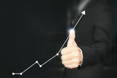 Businessman plan graph growth and increase of chart positive indicators in his business