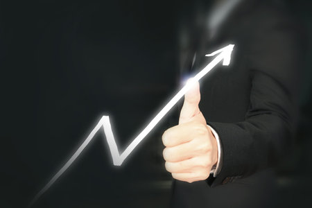 Businessman plan graph growth and increase of chart positive indicators in his businessの写真素材