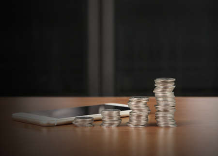 Coins stacked on each other in different positionsの写真素材