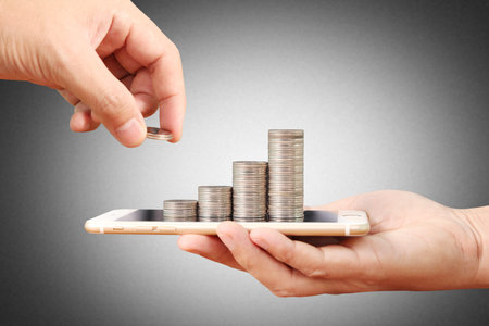 Coins on the smartphone, business in Ecommerce concept
