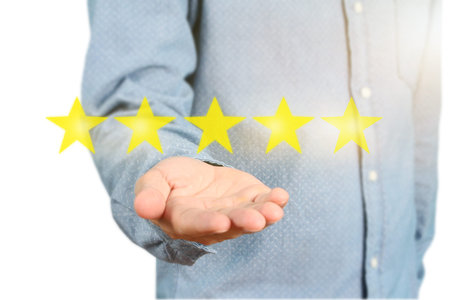 Hand touching five star symbol to increase rating of company concept