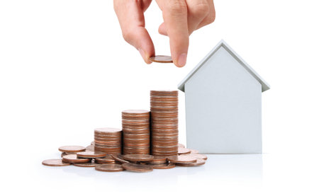 Hand choosing row of coin money house Planning to buy property