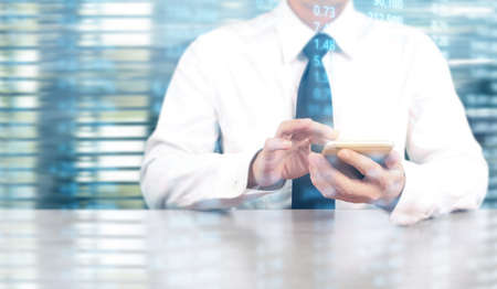 Attractive business man using smartphone in handの写真素材