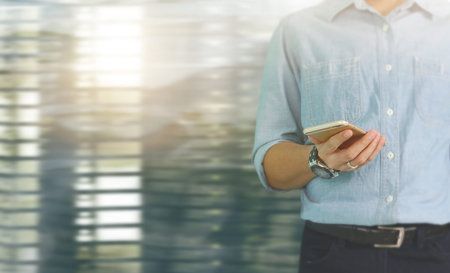 Attractive business man using smartphone in hand