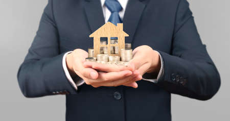 Coins stacked and house on each other in different positions, in a  handの写真素材