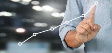 Businessman plan graph growth and increase of chart positive indicators in his businessの写真素材