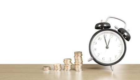 Alarm clock and step of coins stacks on , time for savings money concept, banking and business ideaの写真素材