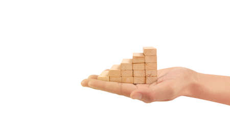 Wood block stacking as step stair with arrow up in a hand. Ladder career path concept for business growth success processの写真素材