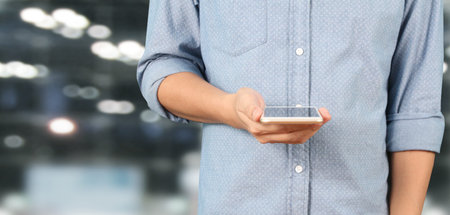 Hand holding the smartphone,device and touching screen