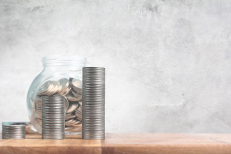 Dropping Coins into Glass Jar Labeled Retirement ,business home idea