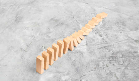 Domino effect stopped by a unique, one strong piece, business ideaの写真素材