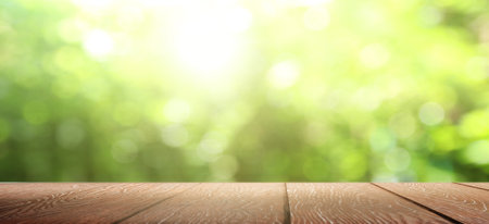 Nature background, Wood table display over blur green tree garden
