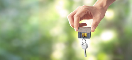 Real estate agent handing over house keys in hand.business ideaの写真素材