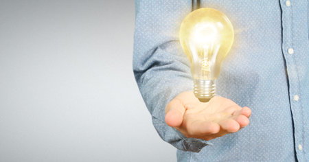 Hand of holding illuminated light bulb, innovation inspiration concept ,business idea