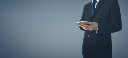 Man hand holding smartphone device and touching screen.business ideaの写真素材