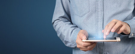Man hand holding smartphone device and touching screen