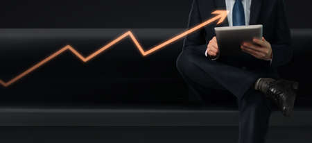 Hands holding a tablet touch computer gadget with  screenの写真素材