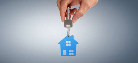 Real estate agent handing over house keys in a handの写真素材