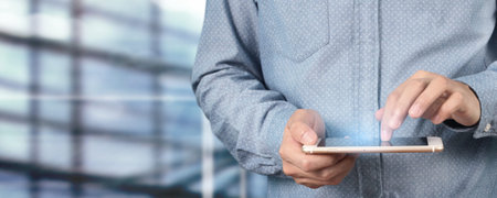 Man hand holding smartphone device and touching screen
