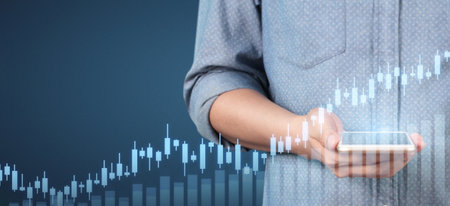 Hand holding smartphone device and touching screen. Stock exchange market concept. businessman...