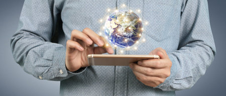 Man hand holding smartphone device and touching screen.